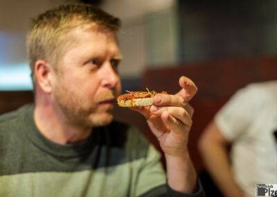 muž jí kousek pizzy v restauraci.